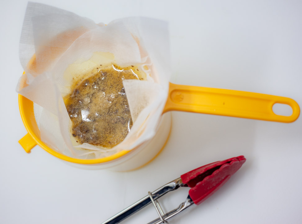 Use a mesh strainer and/or cheese cloth to separate the butter from the ground cannabis